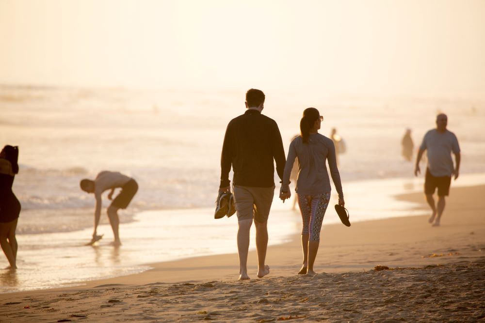 couple walking on siesta key beach