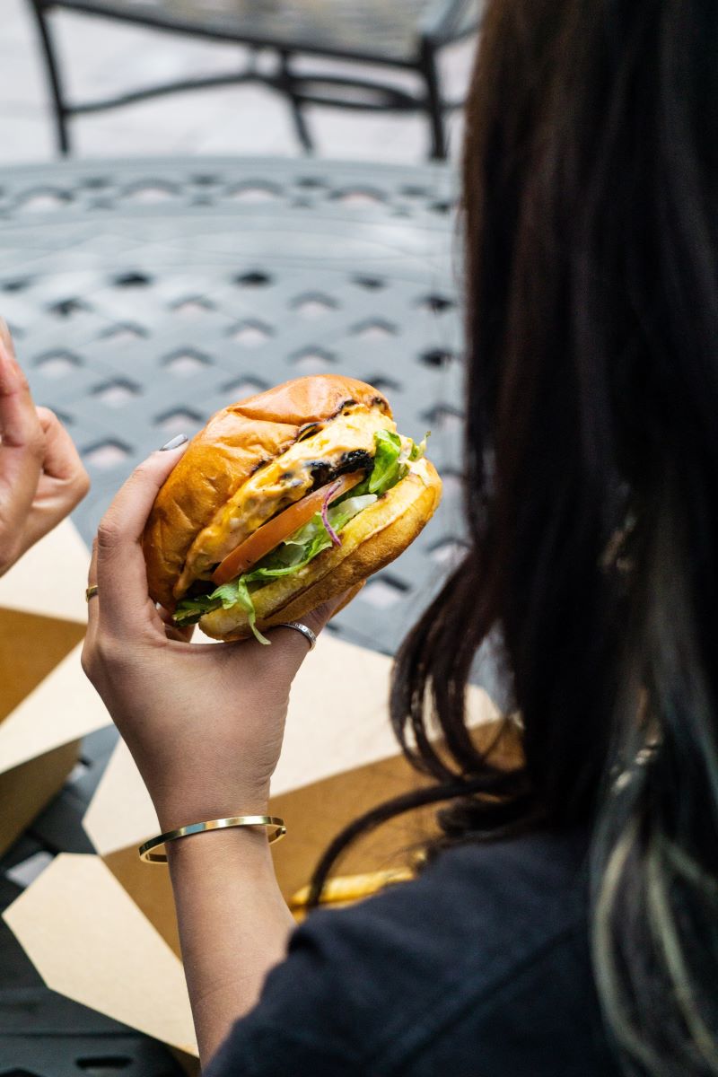 woman eating a burger at siesta key restaurant