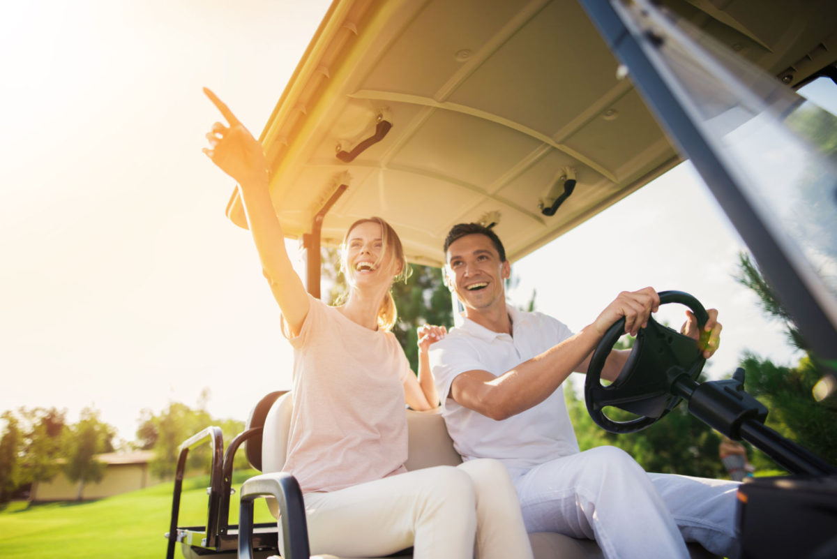 Couple in golf cart navigating Siesta Key 